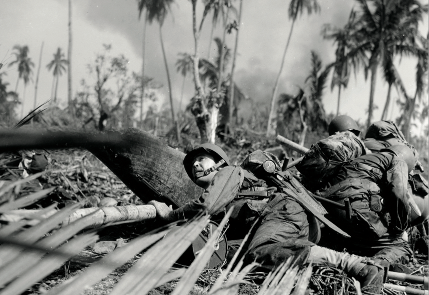 Soldier crouches as enemy fire passes overhead just off one of the beaches on east coast of Leyte Island, Philippines, October 20, 1944 (NationalArchives and Records Administration/Carl Wienke/U.S. Army Signal Corps)